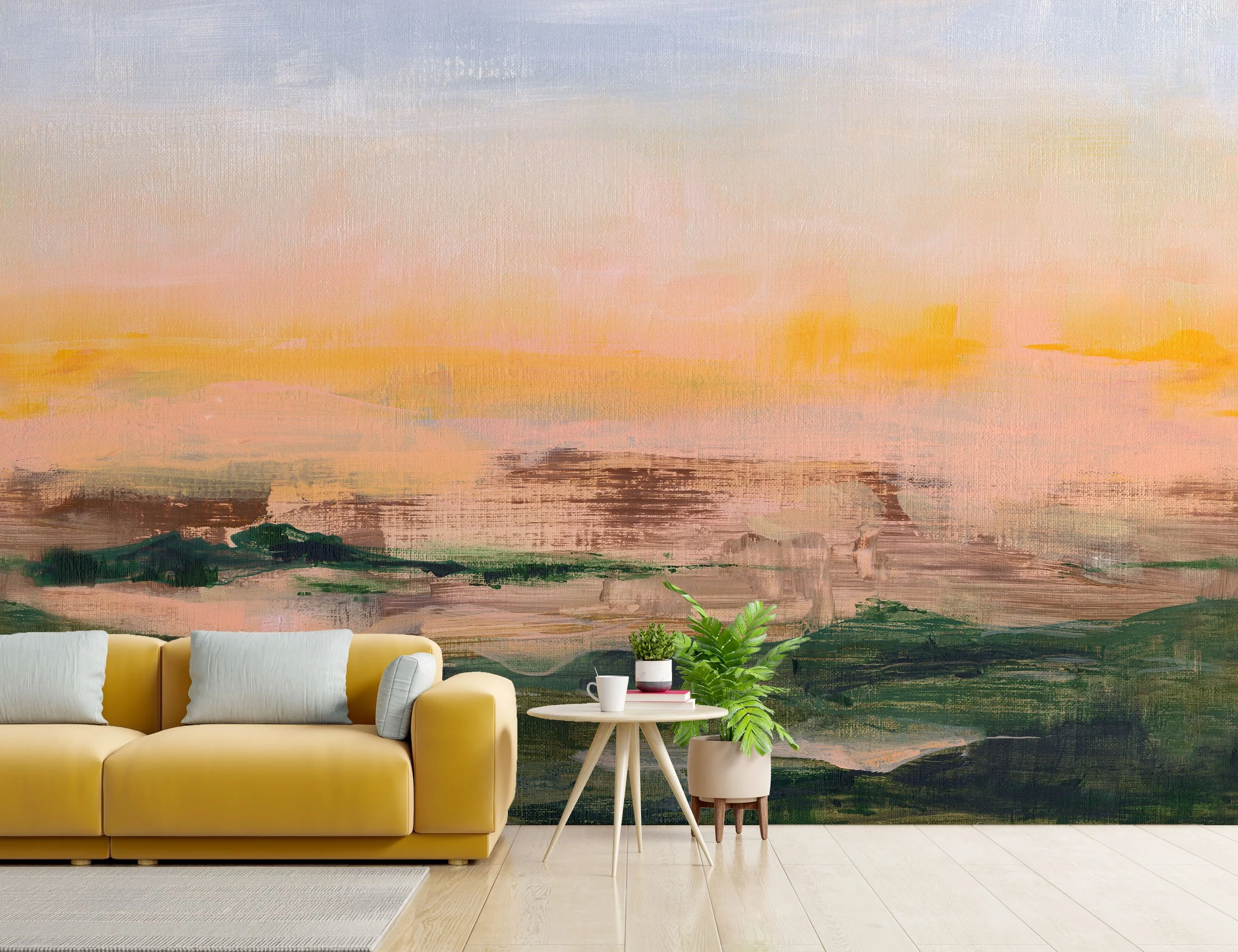 Hand-painted mural of a vivid pastel sunset landscape in pink, gold, and green tones behind a modern yellow sofa and potted plants