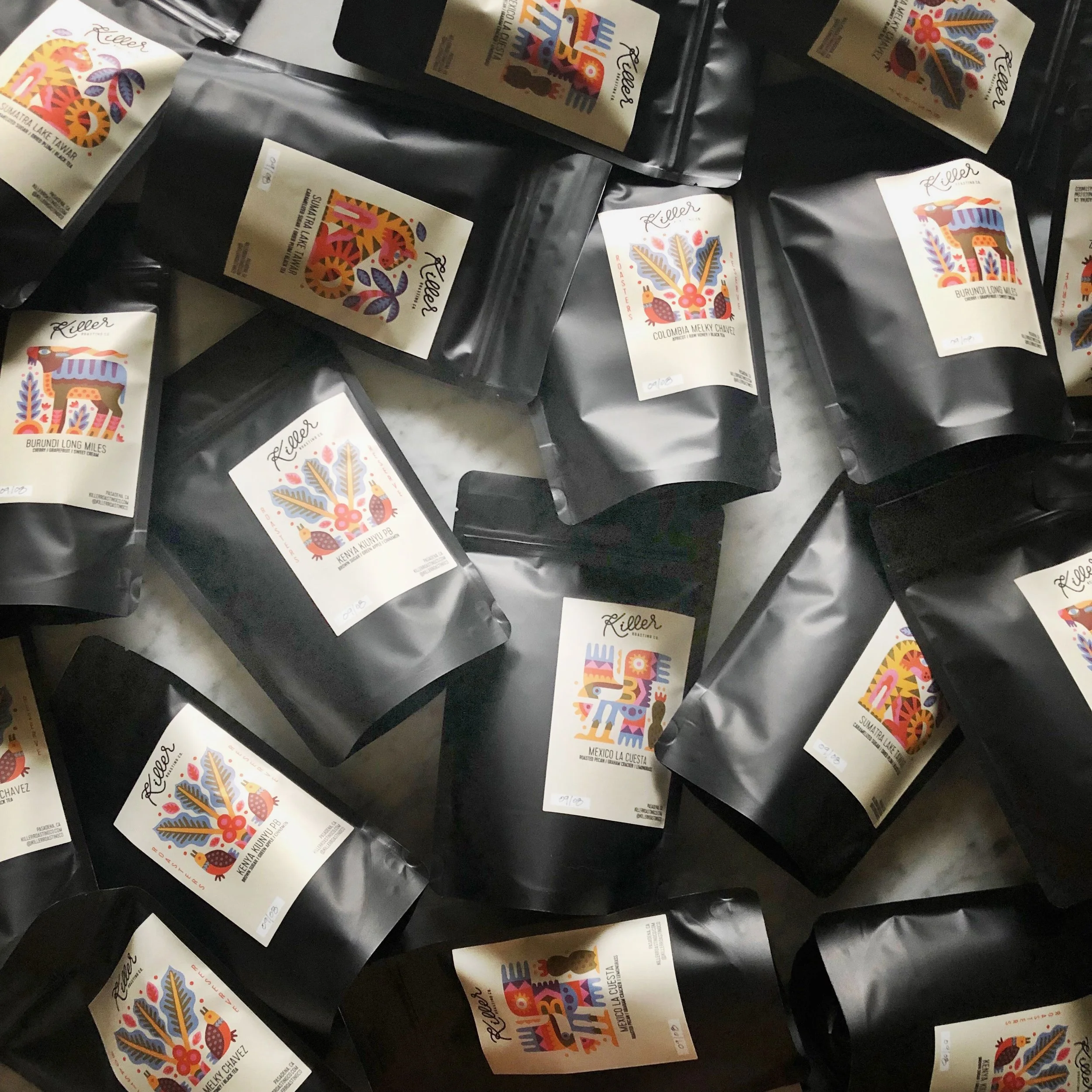 Packages of small-batch coffee featuring colorful illustrated labels.