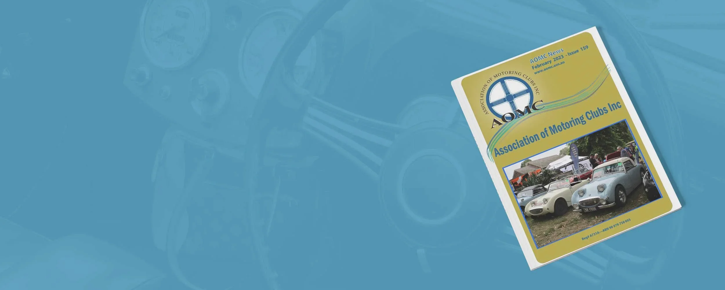 A magazine titled 'AOMC' with a cover photo of vintage cars parked outdoors at a car show or gathering, with people in the background. The magazine is the February 2023 issue of the 'Association of Motoring Clubs Inc.'
