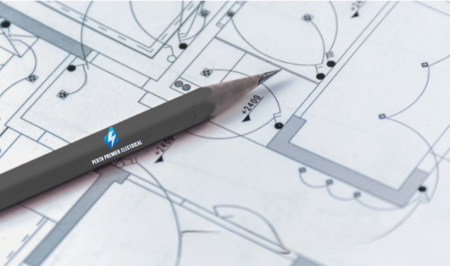 A pencil resting on top of architectural blueprints of a building.