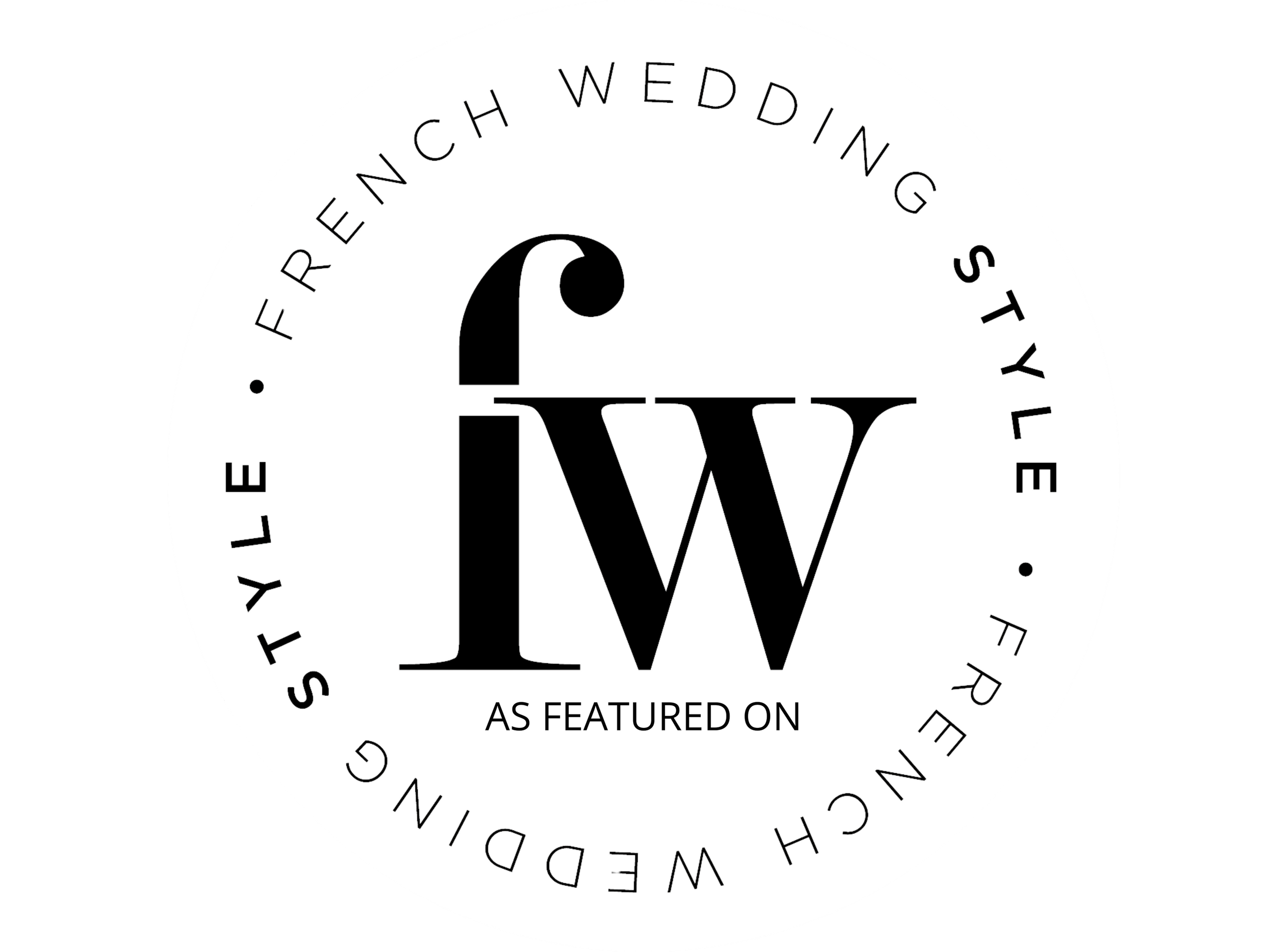 Circular award badge with a large black letter 'W' and smaller black letter 'I' and 'W' overlapping, surrounded by the text 'FREEDOM’ WEDDING STYLE' and 'AS FEATURED ON' at the bottom.