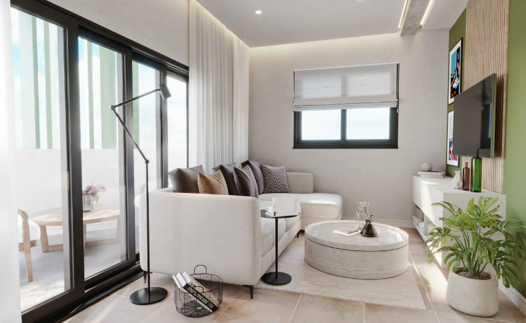 Modern living room with a beige sectional sofa, throw pillows, a round coffee table, large windows with white blinds, a white media console, a flat-screen TV, and a potted plant.