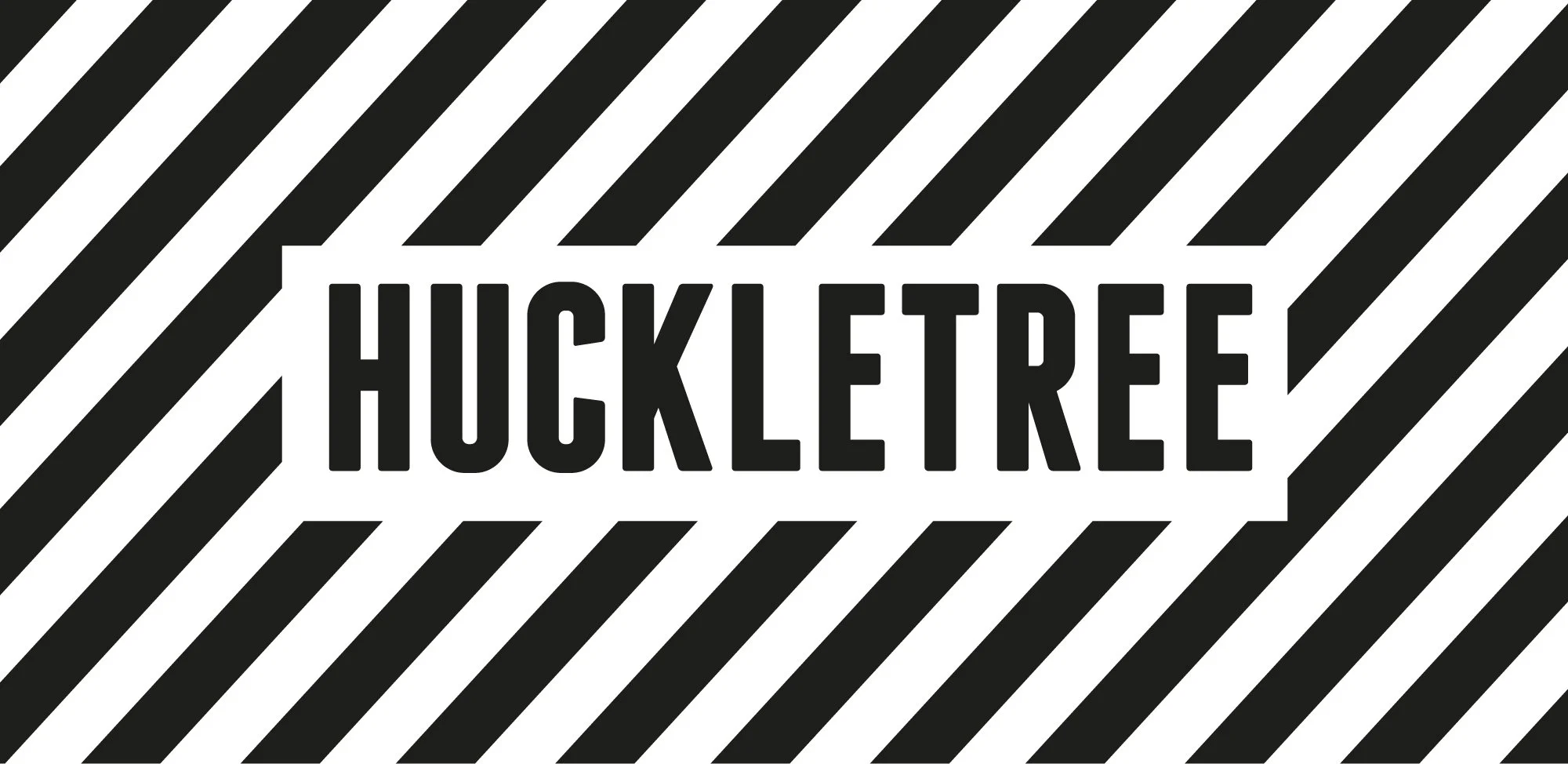 Black and white striped background with the text 'Huckletree' in bold black letters in the center.