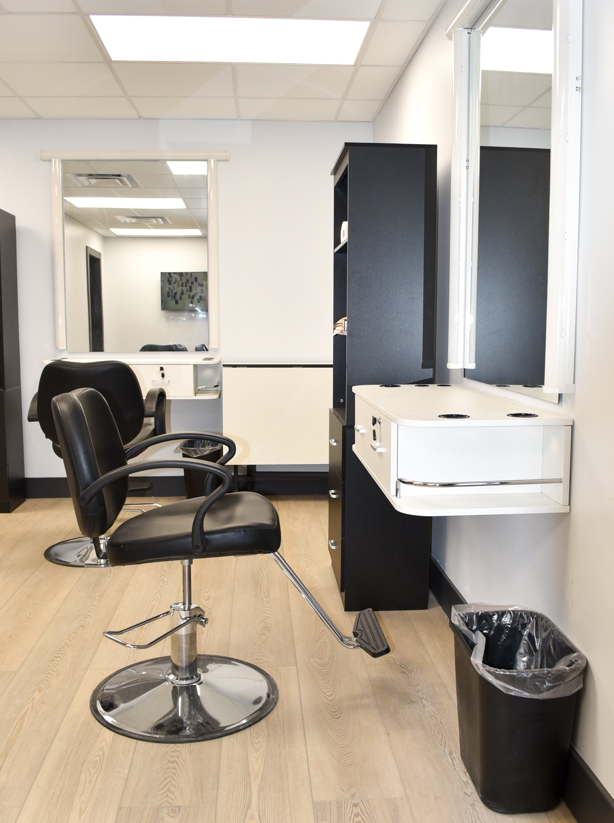 Professional hair and makeup lit mirrors, salon chairs, and changing rooms
