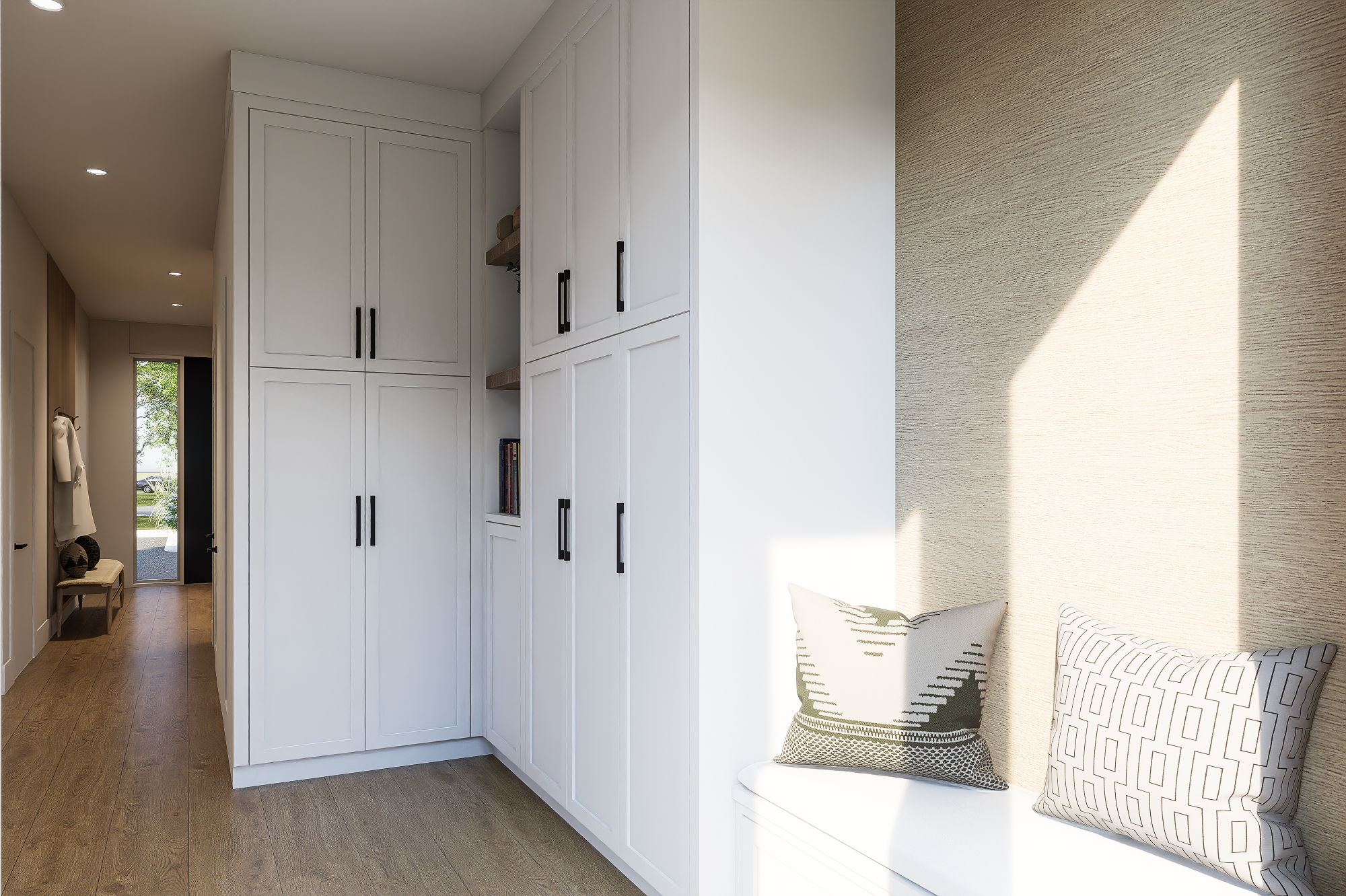 Interior of a modern home with white built-in cabinets, a window seat with pillows, and sunlight casting on the wall.