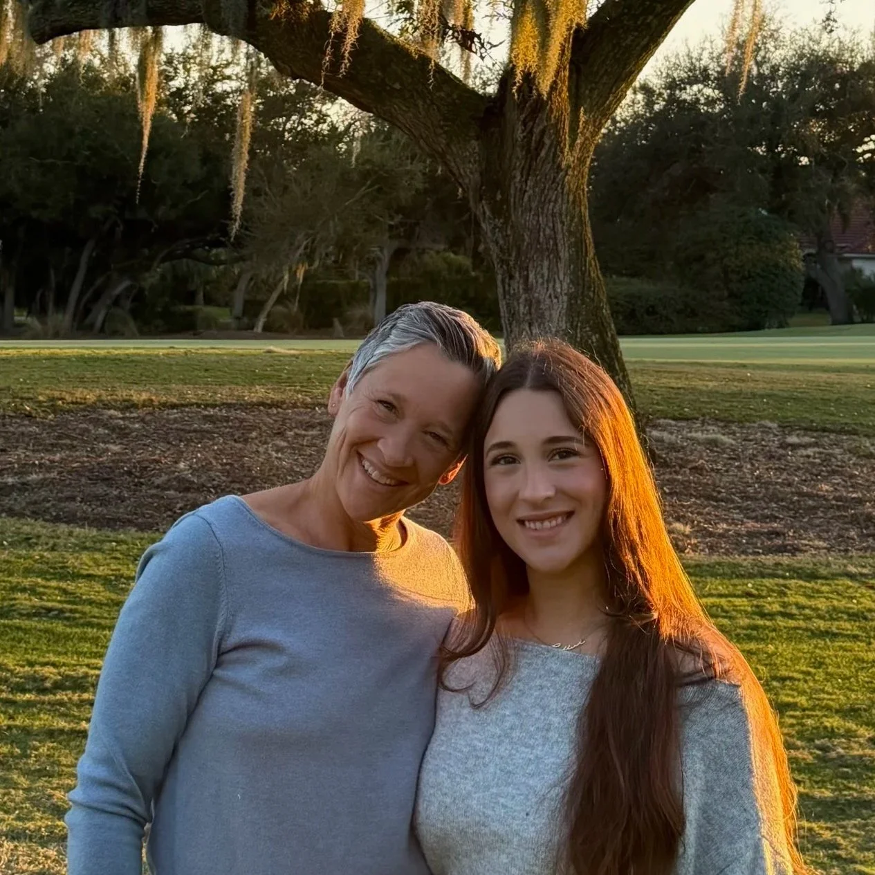 Co-Founders, Gillian and Tammy Marino are smiling together standing in nature