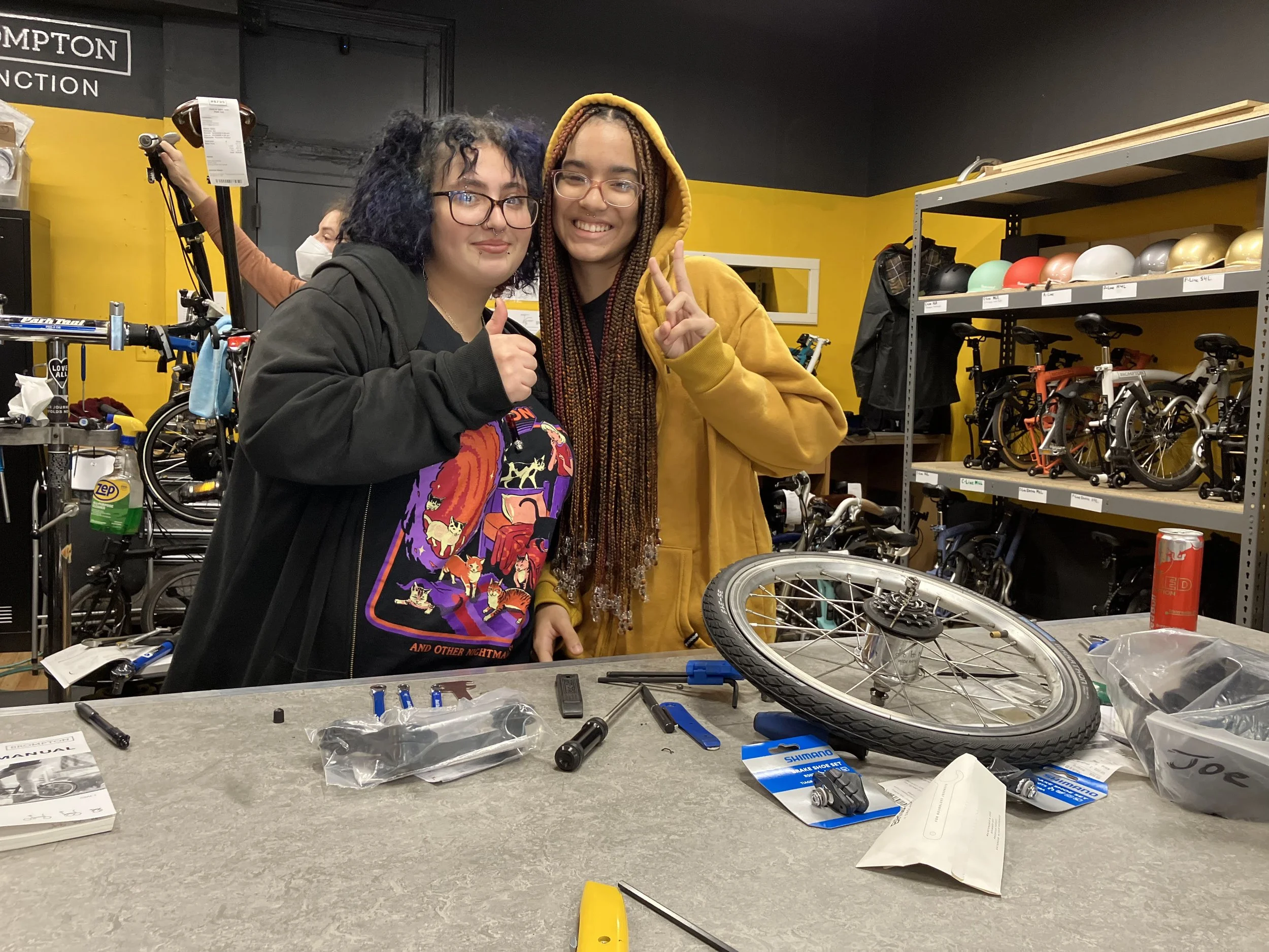 Two students working at bicycle shop internship.
