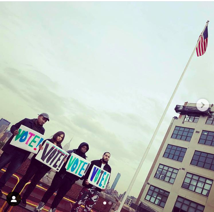 Group of City-As-School students posing outdoors with activist posters. 