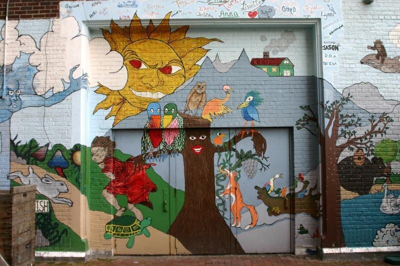  Colorful mural of trees, clouds, sun and more on City-As-School exterior walls. 