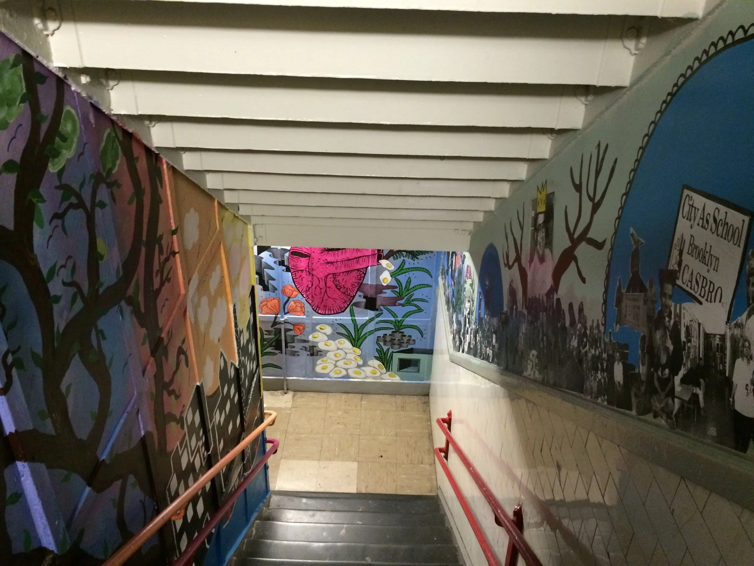  Colorful  City-As-School murals lining interior staircase. 