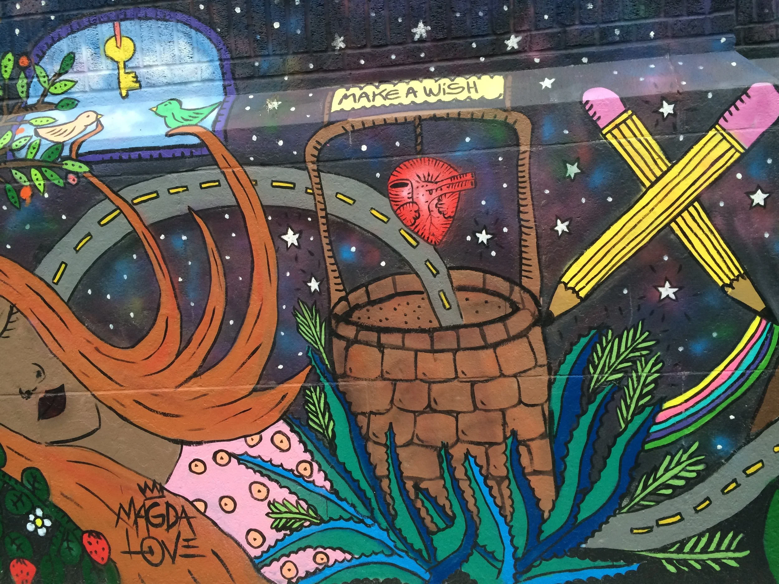  Colorful mural of young person against night sky at City-As-School . 