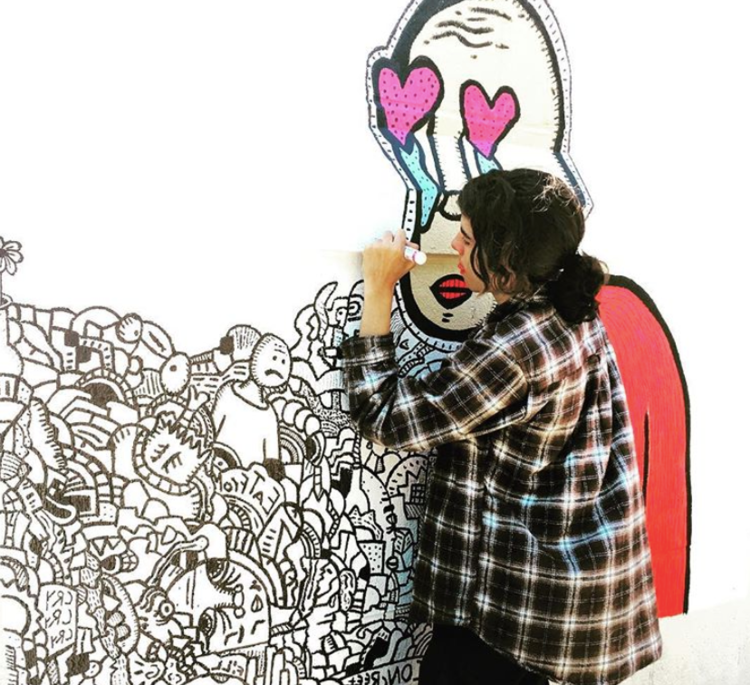 students walking past colorful mural on the street.