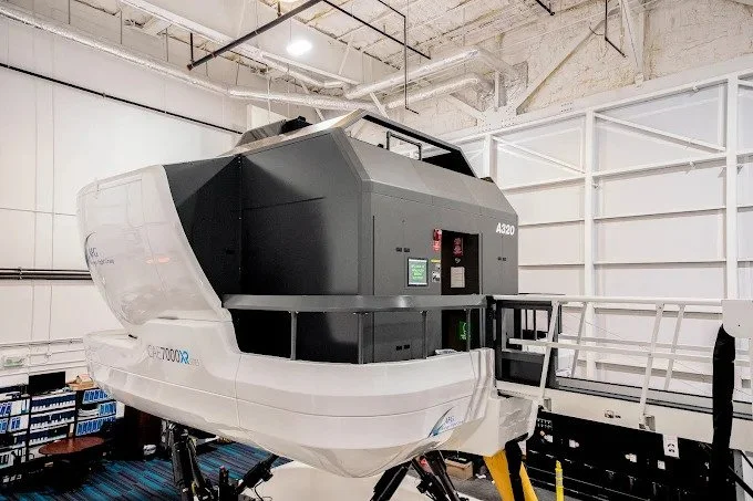 Another perspective of the flight simulator, possibly showing the hydraulic systems that allow for realistic motion.