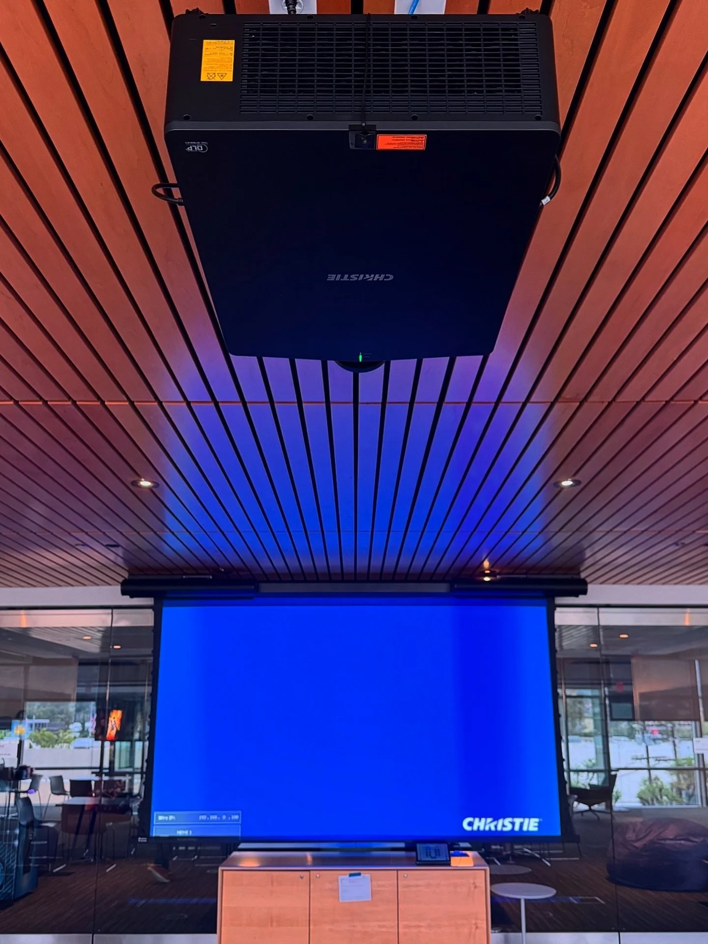 A modern, open collaboration workspace designed for high impact meetings and seamless presentations. This project was customized to our client&rsquo;s workflow, featuring a @christiedigital Projector, @biamp_systems Audio System, and @crestron Contro