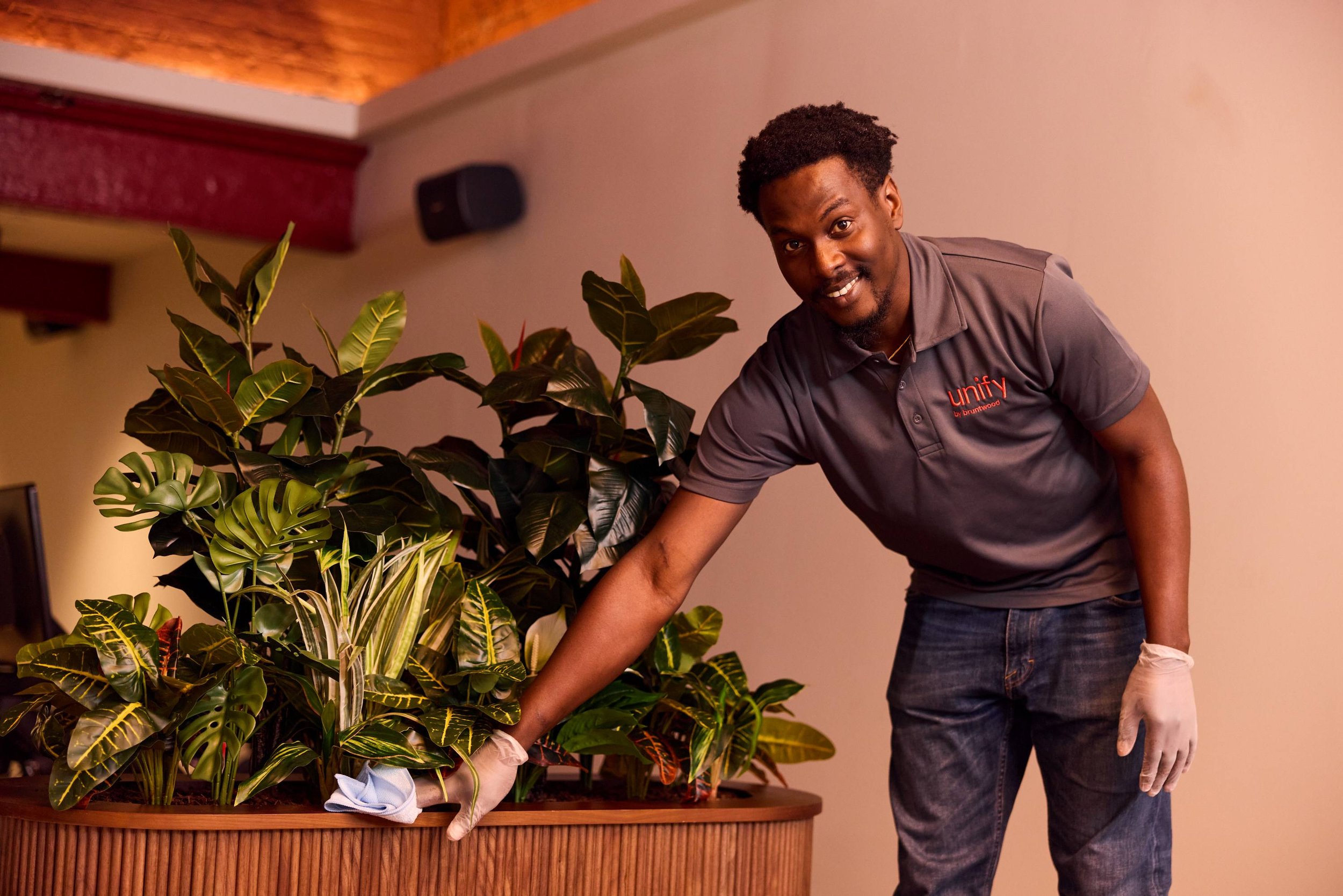 Unify team member cleaning a planter