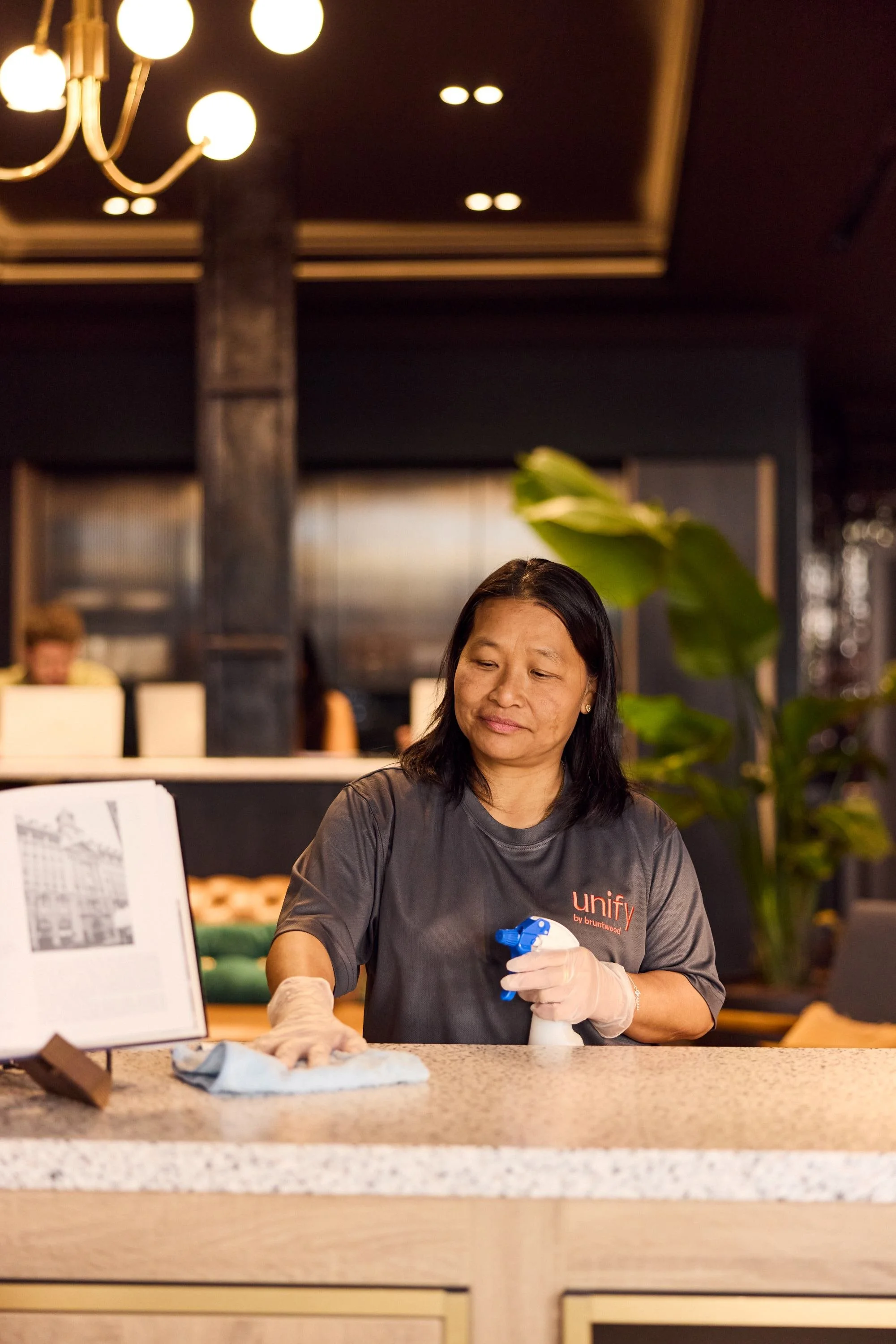 Unify team member wiping a worktop