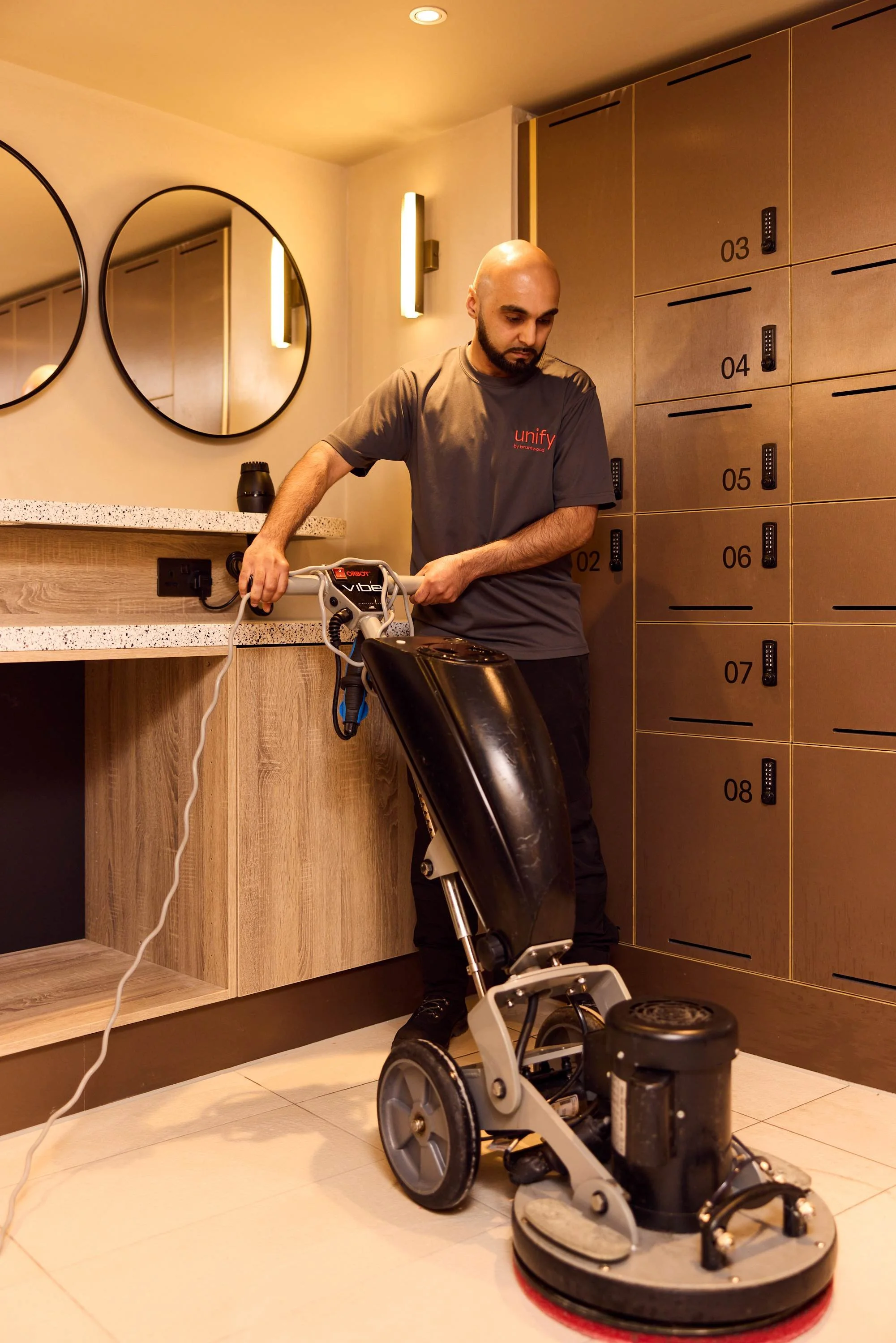 Unify team member with floor cleaner