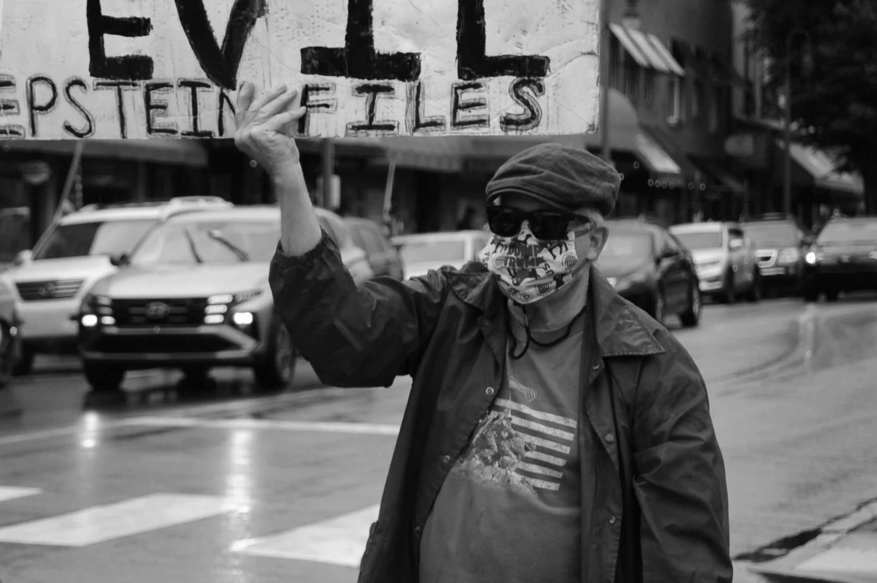    Waynesville, NC - May 23rd, 2026.    A demonstrator walks along the sidewalk with his message.   