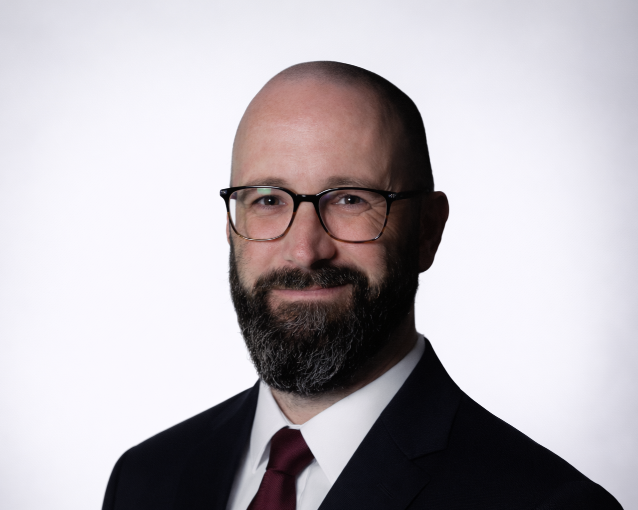 Professional man in suit wearing glasses.