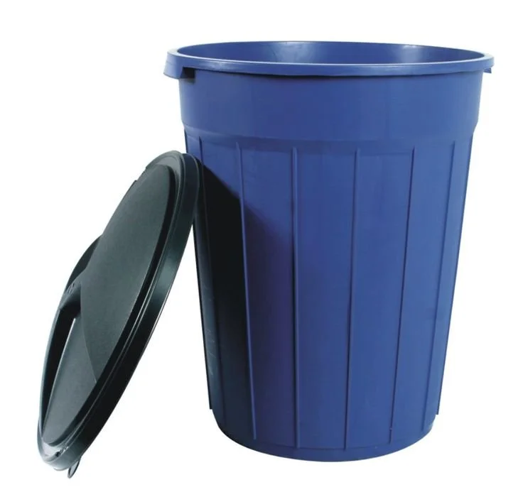 A large blue plastic trash can with a black lid leaning against it.