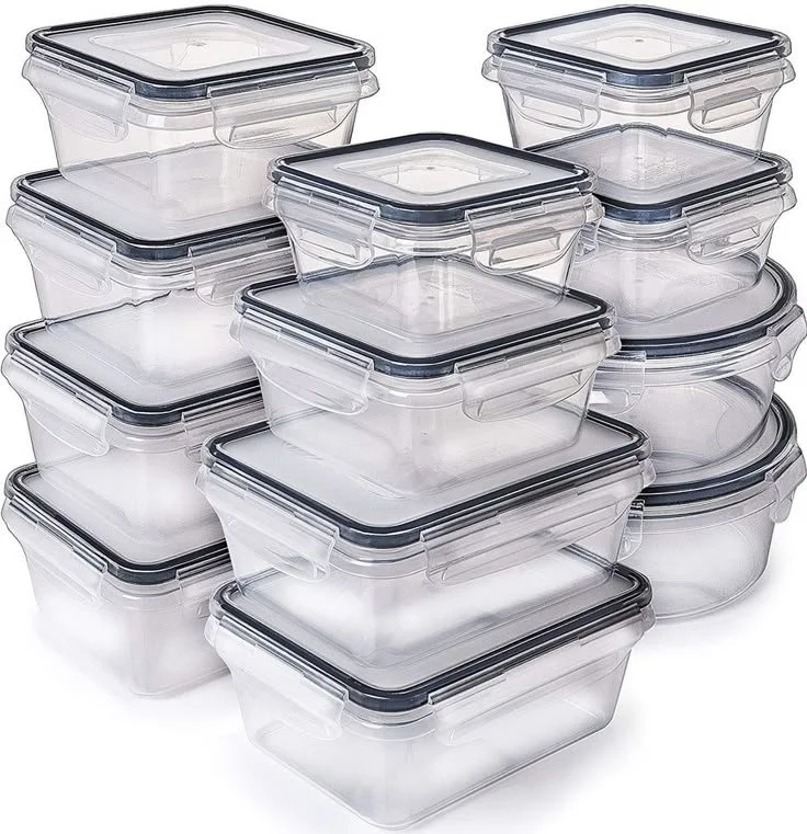 Multiple clear plastic food storage containers with black sealing lids stacked together.