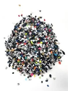 Small multicolored pieces of plastic or rubber scattered on a white surface.