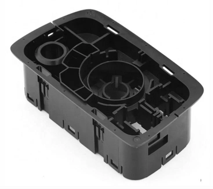 Black plastic electrical junction box with internal compartments and mounting points.