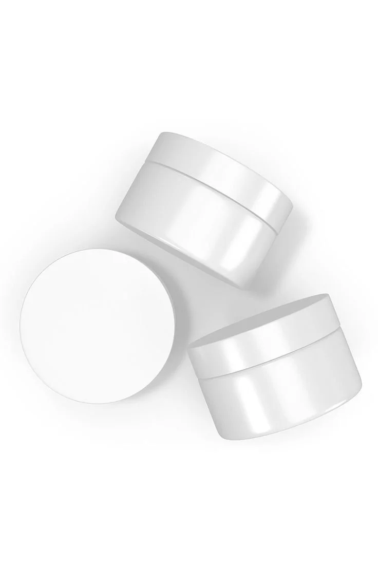 Three empty white cosmetic jars and one white round container on a white background.