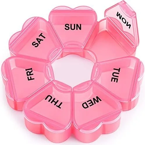 Pink plastic pill organizer with compartments labeled for each day of the week, starting with Sunday and ending with Saturday.