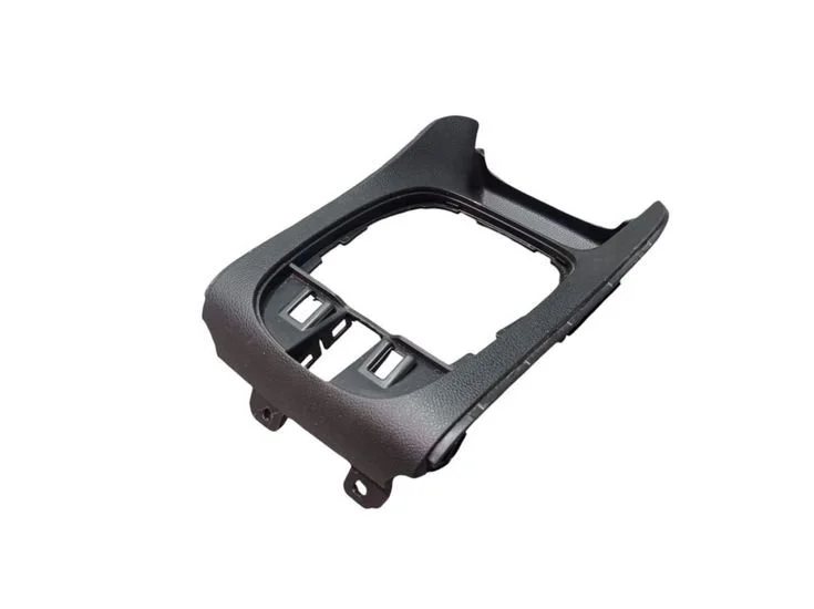 Black plastic car dash panel frame with cutouts for switches and display.