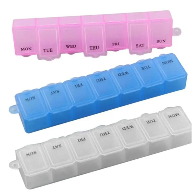 Three plastic pill organizers in pink, blue, and white, each with compartments labeled for days of the week.