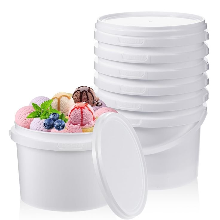Six white plastic containers stacked with one container open revealing multicolored ice cream scoops garnished with blueberries and mint leaves.