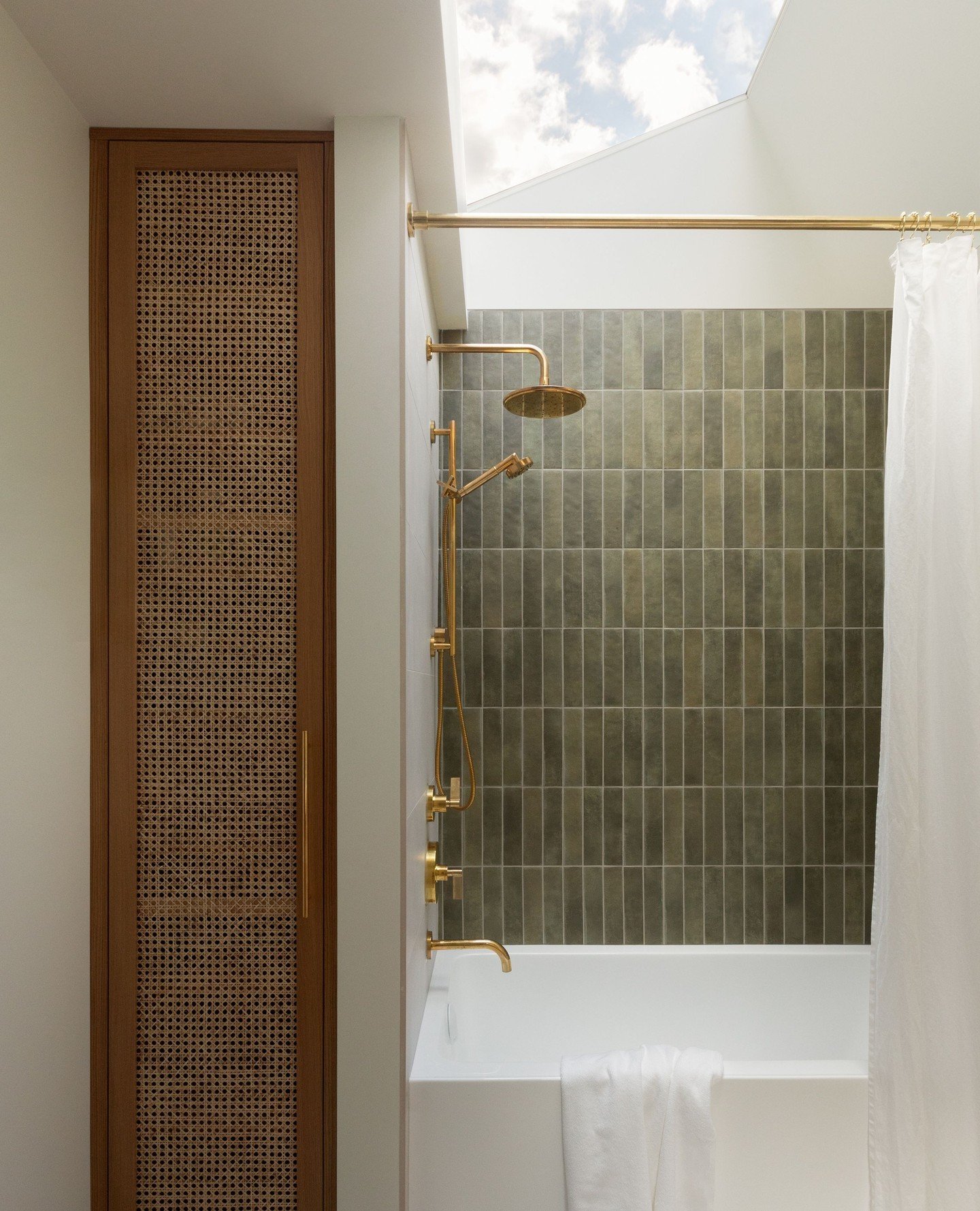⁠Natural light, warmth, and quiet contrast. This bathroom is a study in texture and restraint. Cane paneling, unlacquered brass, soft green tile, and the star of the show: that skylight.⁠
⁠
We design spaces that feel personal, not prescriptive. It's 