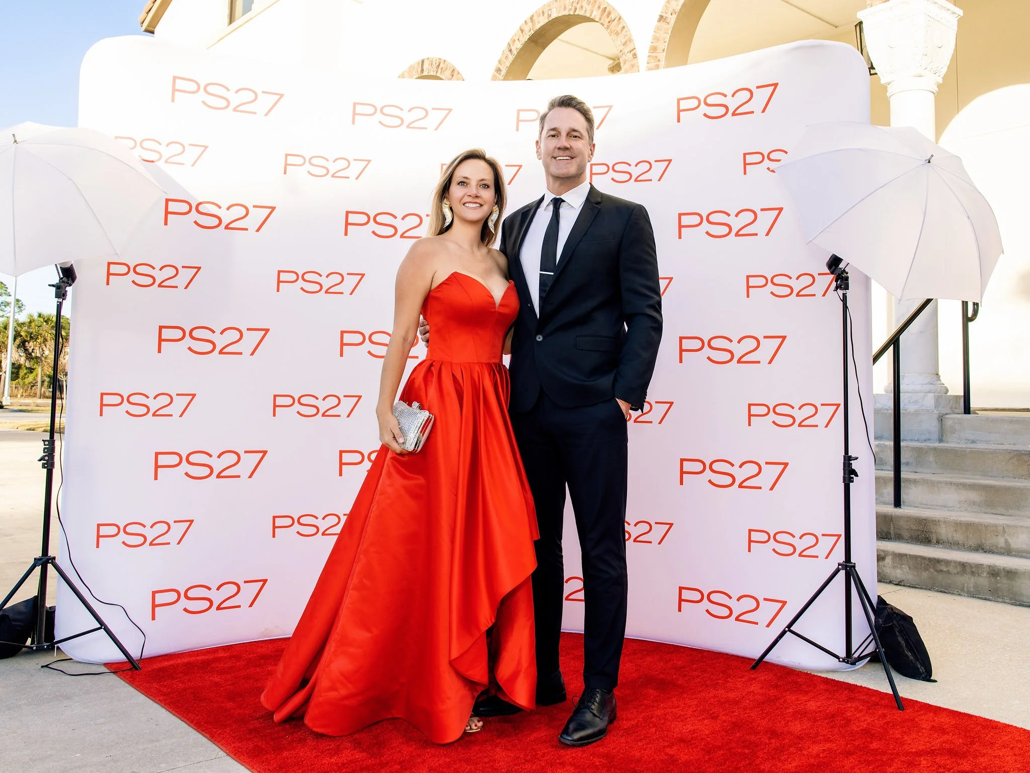 Couple in formal wear posing on the red carpet