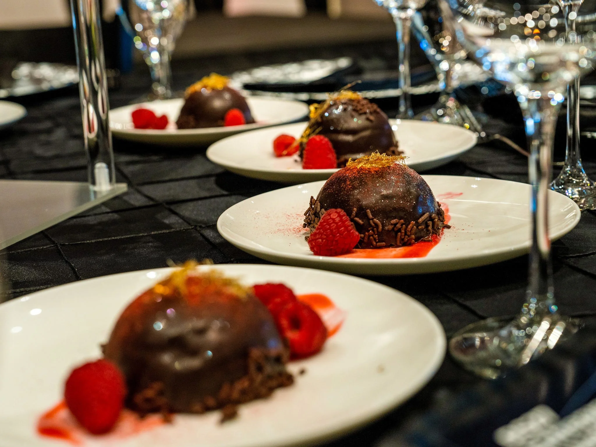 Chocolate dessert plated on a black table at a gala dinner