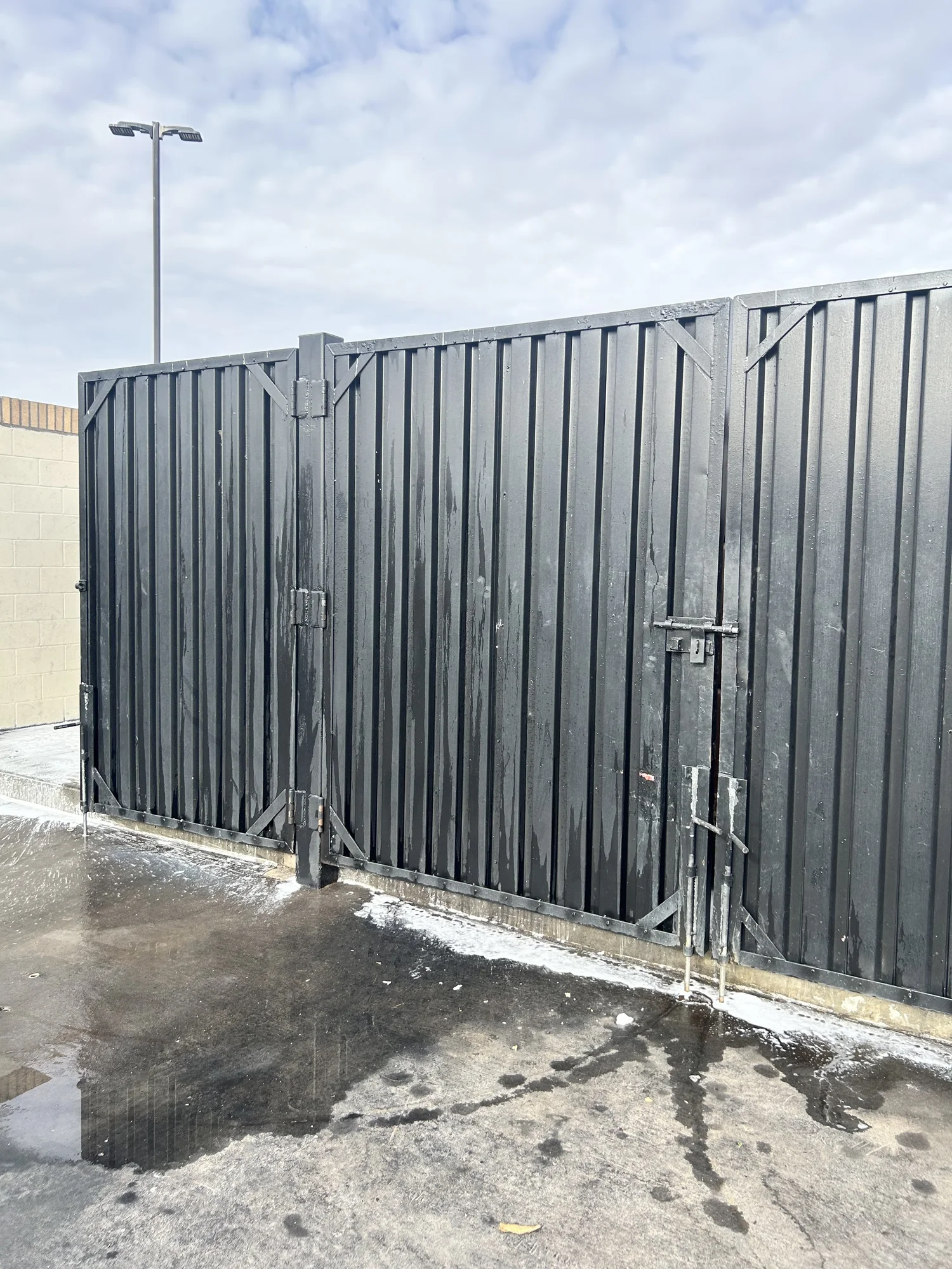 Dirty dumpster pad and surrounding concrete before cleaning in Las Cruces NM