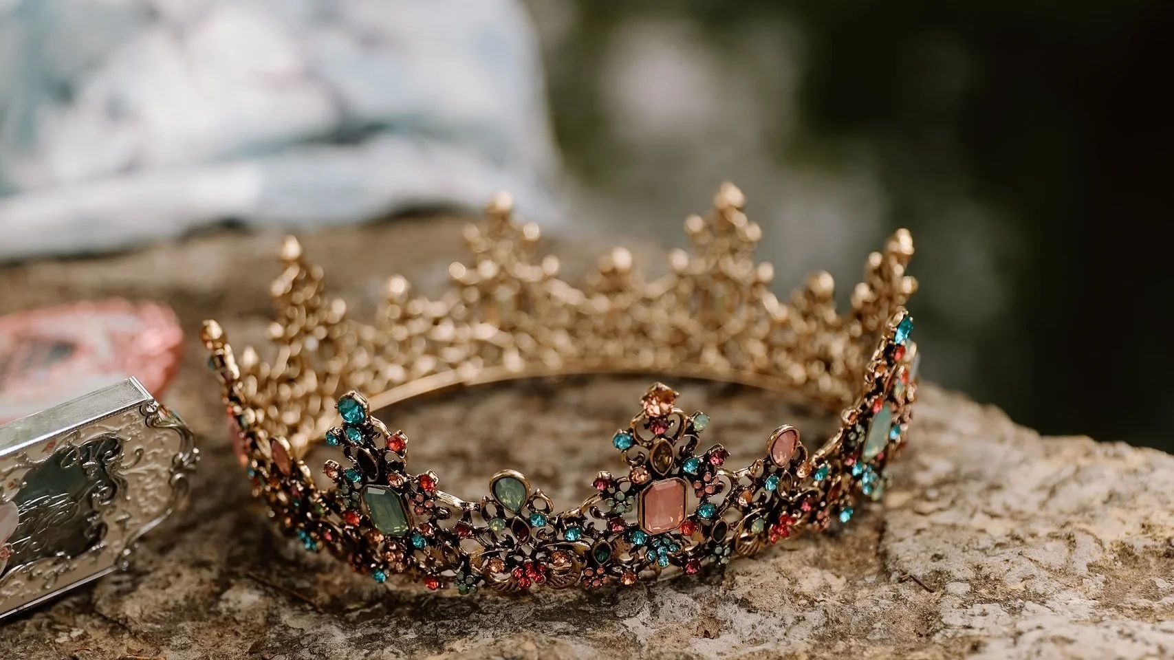 a bejeweled crown on top of a rock