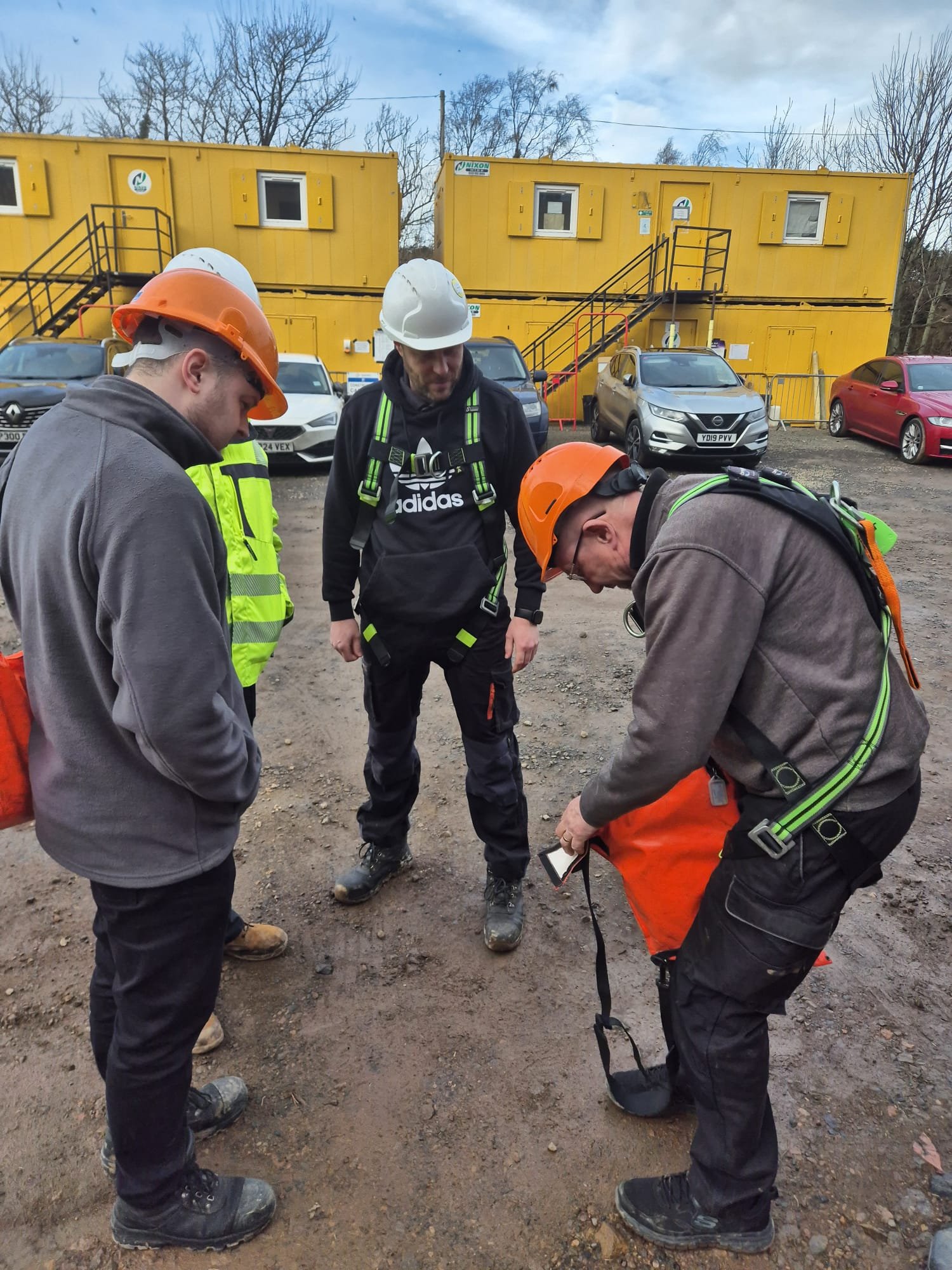 AD Biogas training, people gathered round in PPE reviewing work