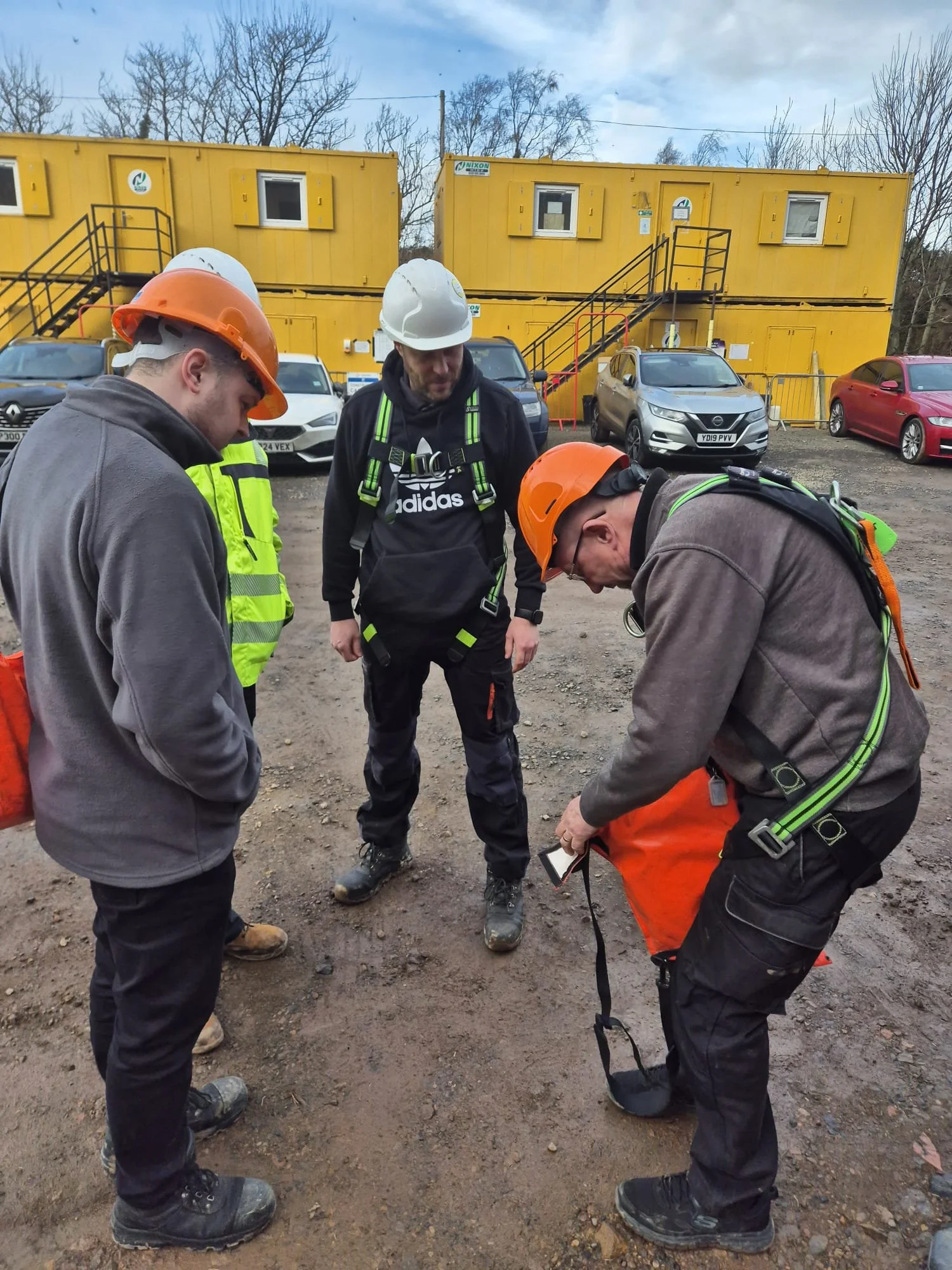 AD Biogas training, people gathered round in PPE reviewing work