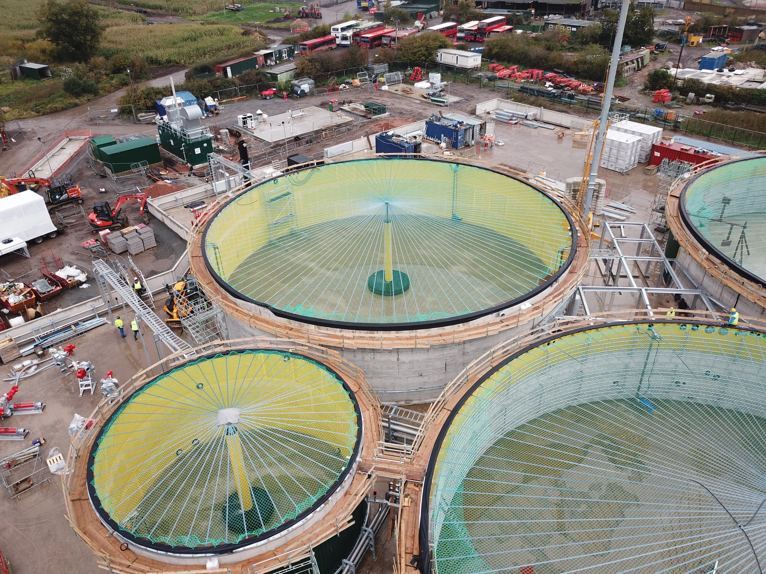 AD site construction, green netting on tankers being built