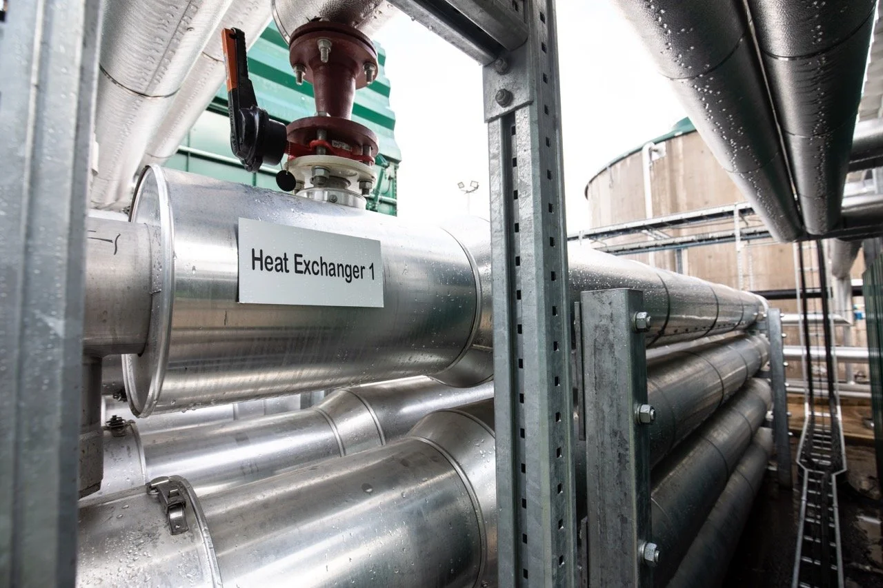Close-up of biogas pipework, valves, and pressure gauges on an AD plant