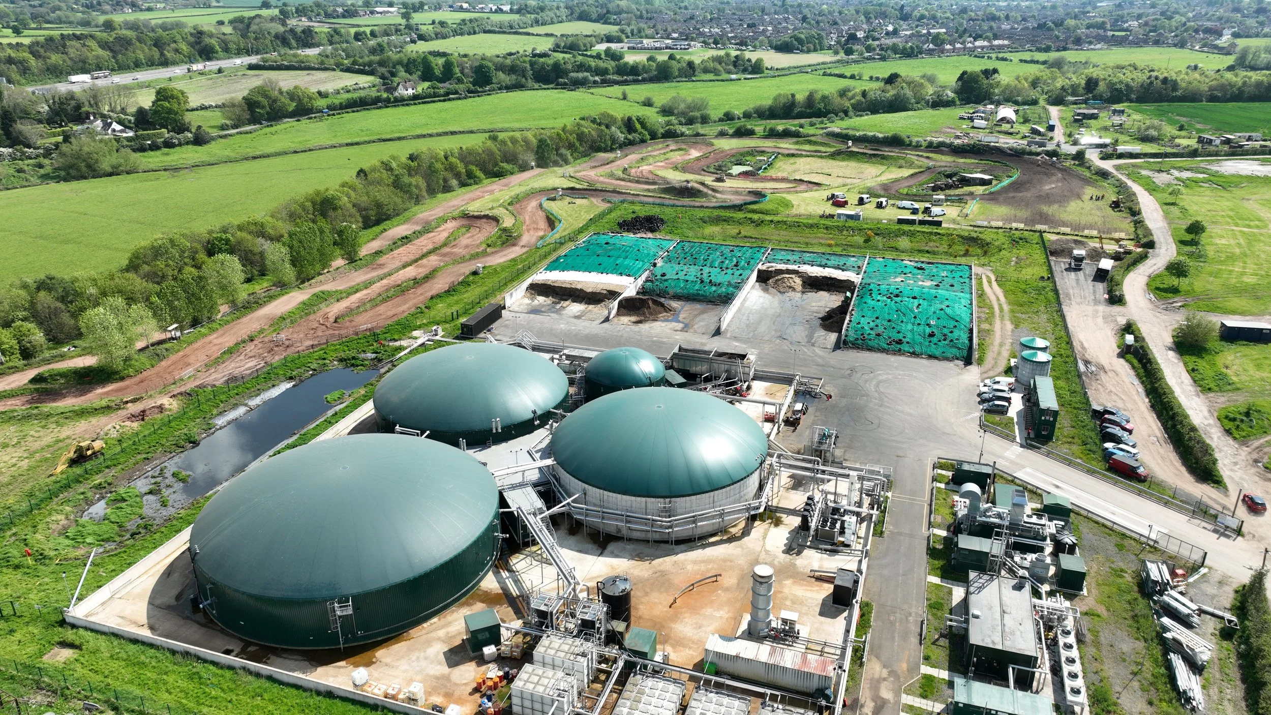 Aerial view of a commercial AD plant showing digesters, gas holders, and ancillary infrastructure.