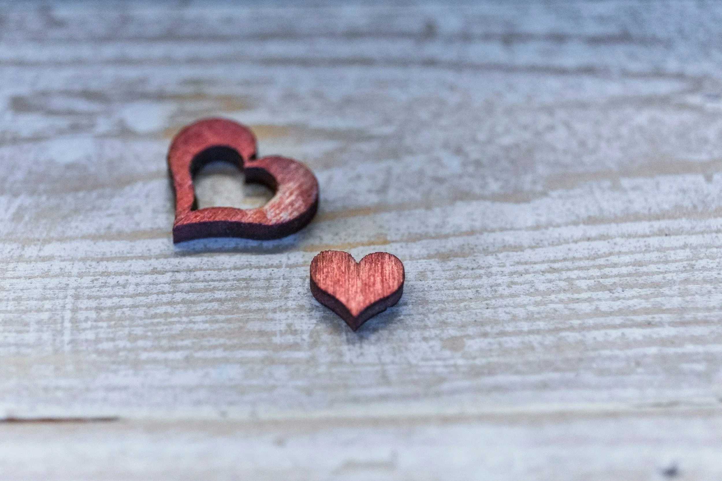 two hearts on a wood background