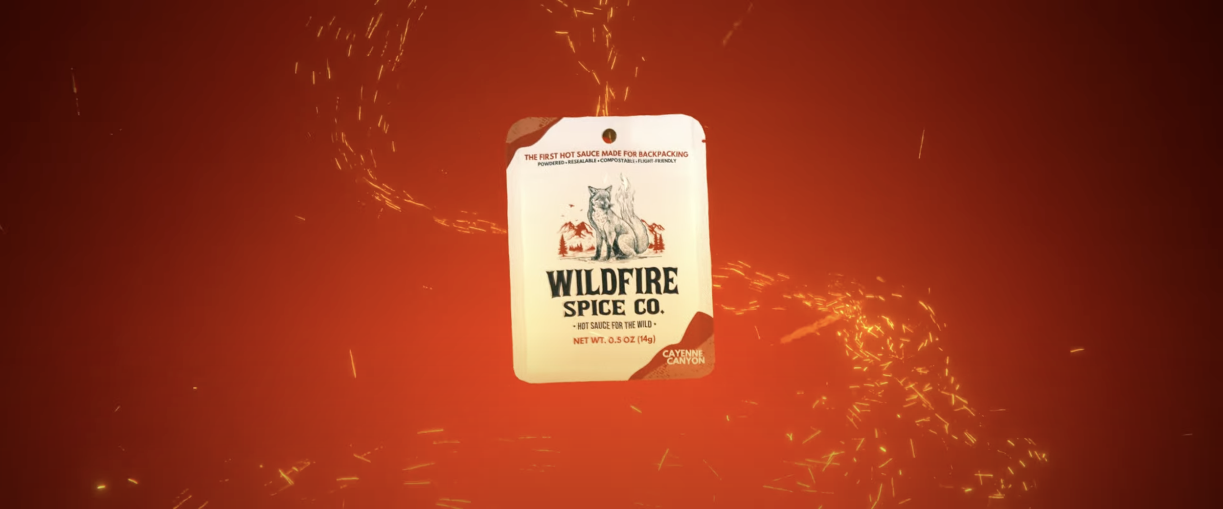 Package of wildfire spice from Wildfire Spice Co., featuring a logo with a fox, in a fiery background with sparks.