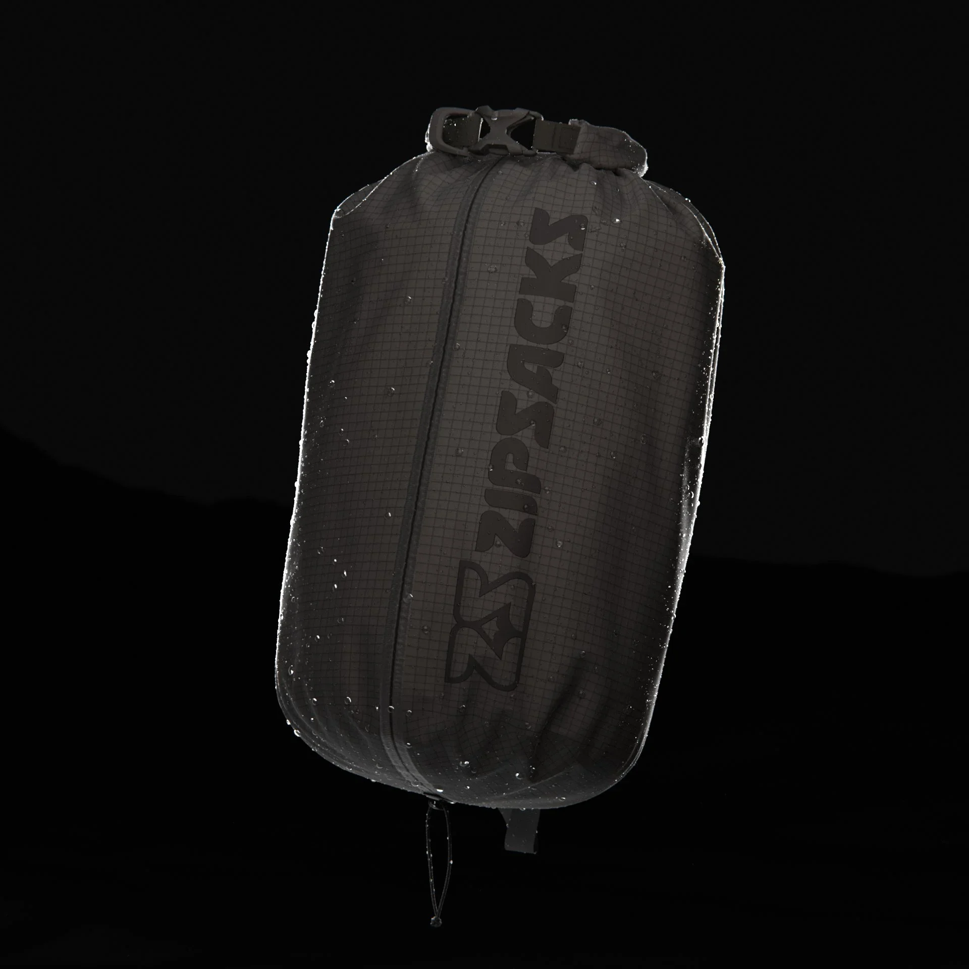 A black SPIRE 26 backpack hanging against a dark background, wet with water droplets.