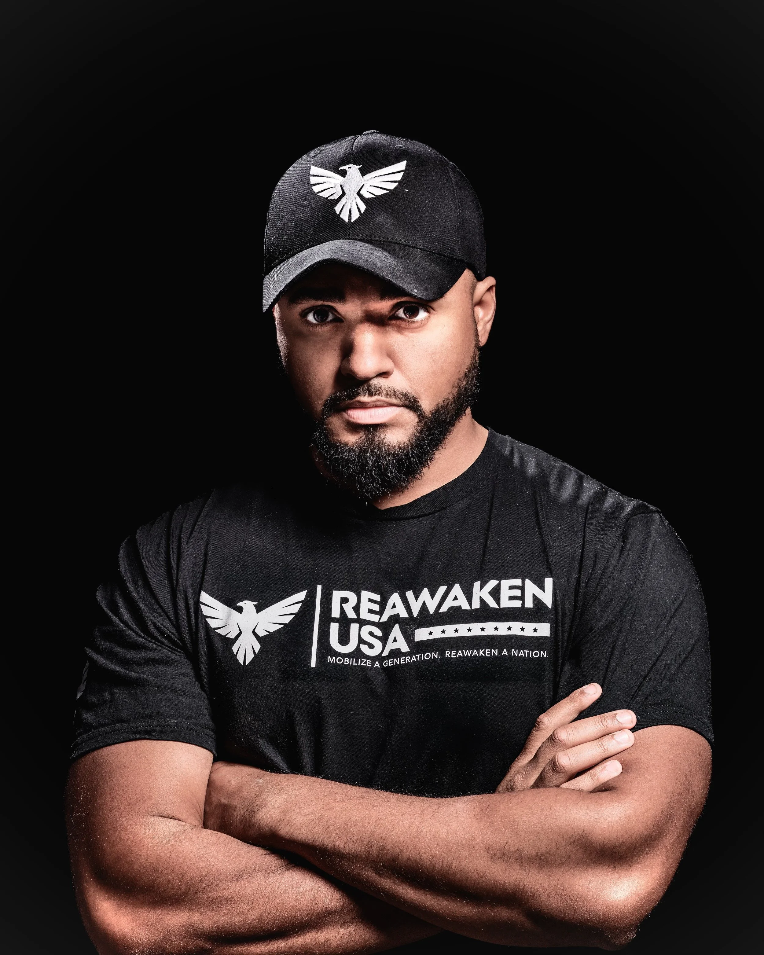 James Owen crosses his arms and looks directly at the camera.