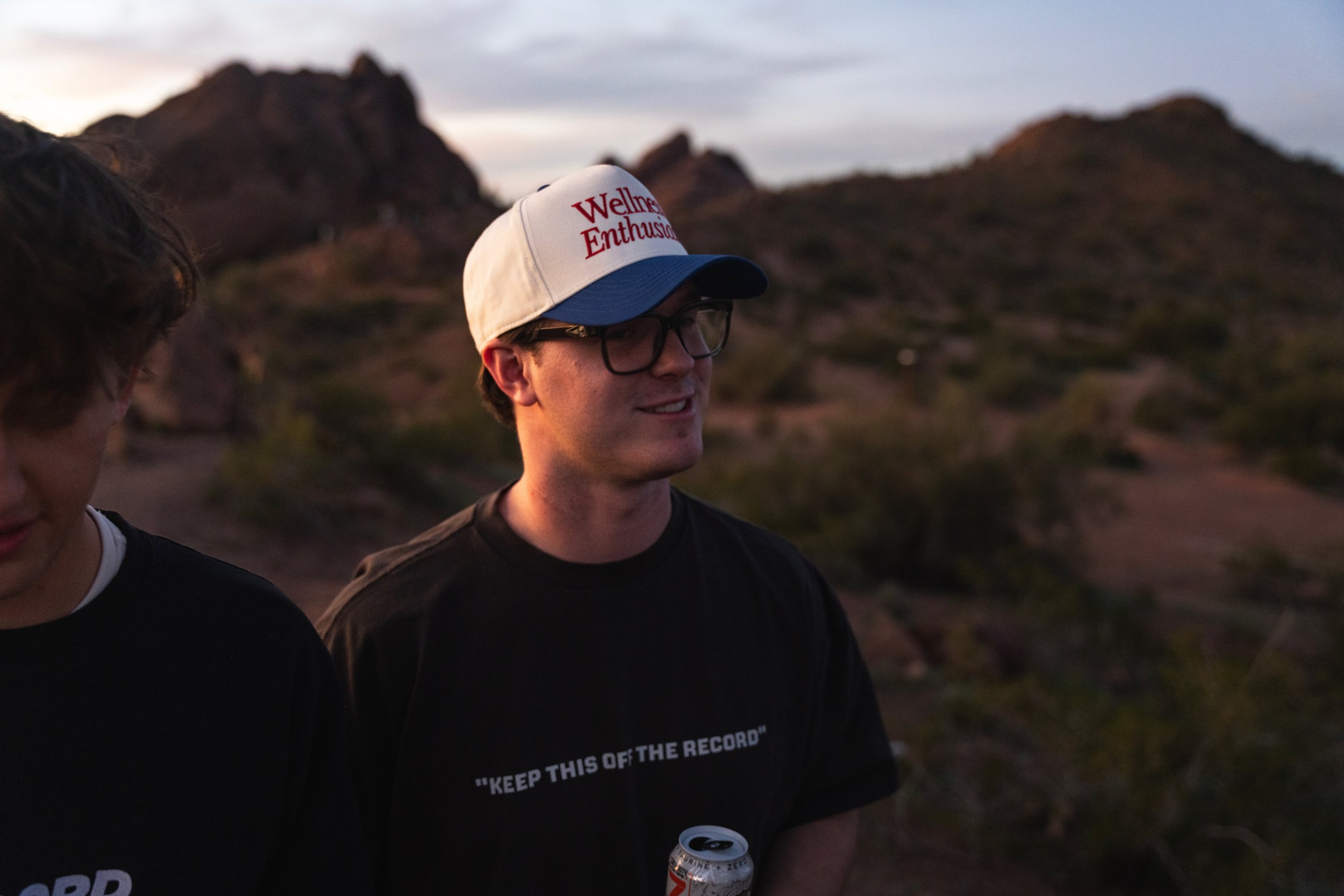 Stryder Bigler is mogging with a desert background behind him during sunset.