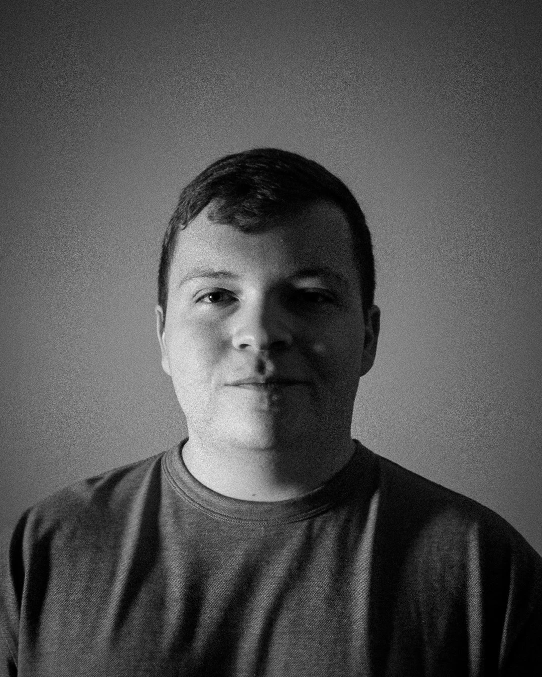 AJ Raber looking directly at camera in black and white.