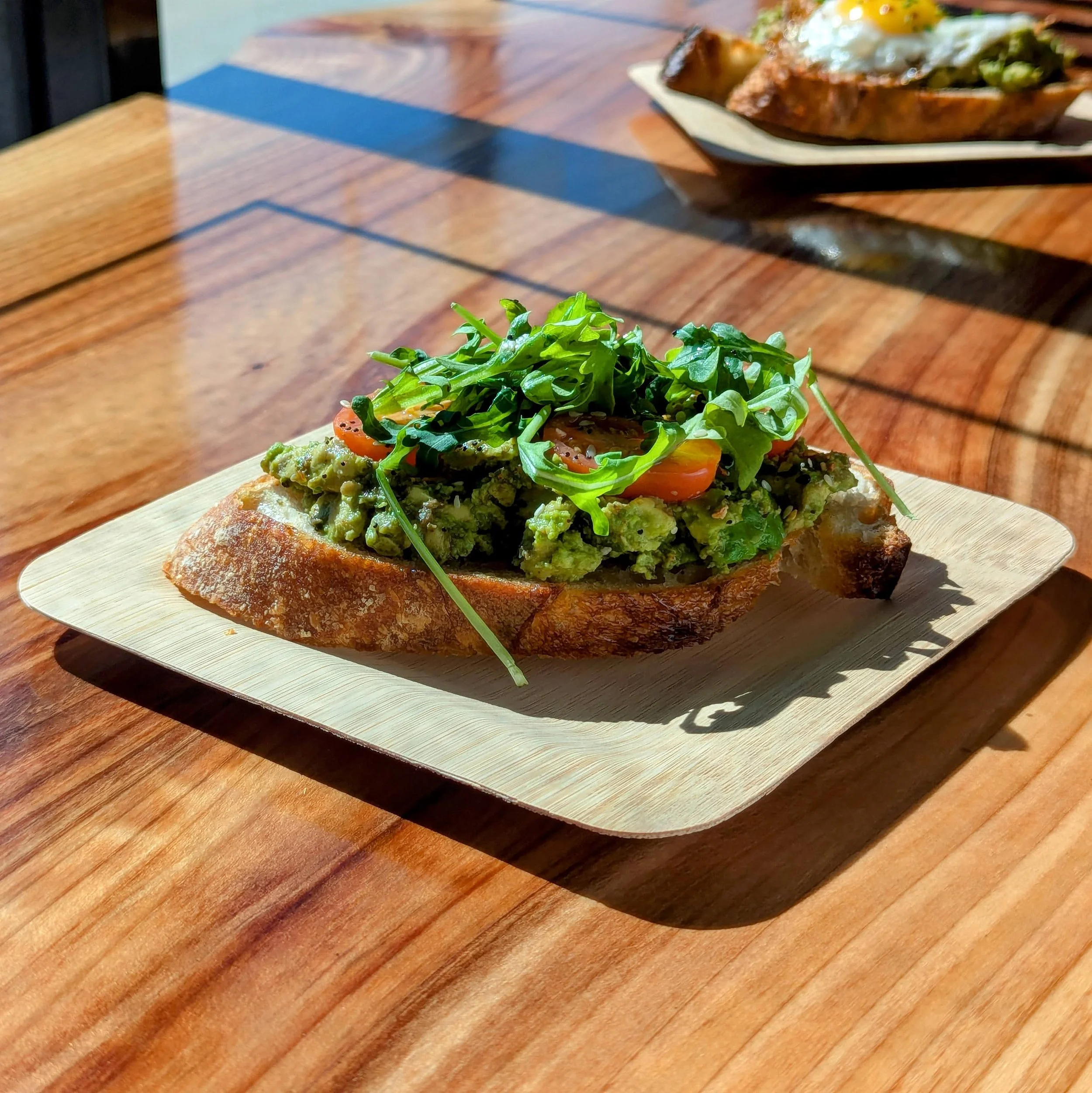 avocado tomato and arugula toast