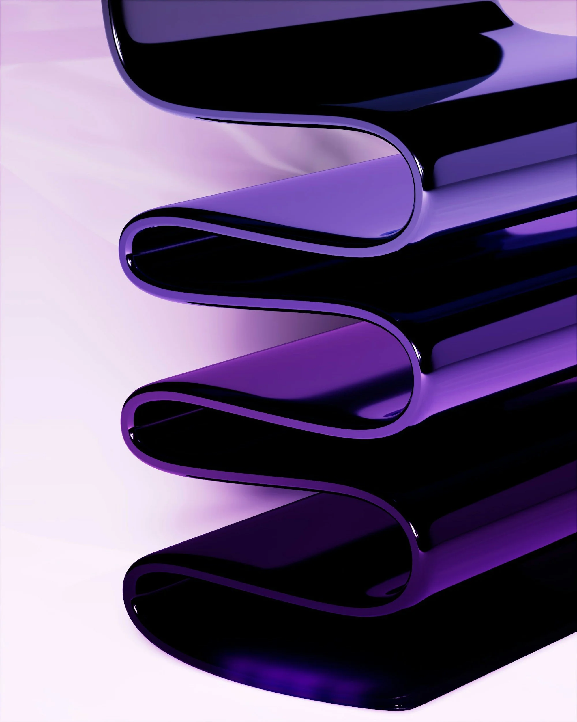 Close-up of a glossy black and purple abstract sculpture with curved, tubular shapes stacked on each other.